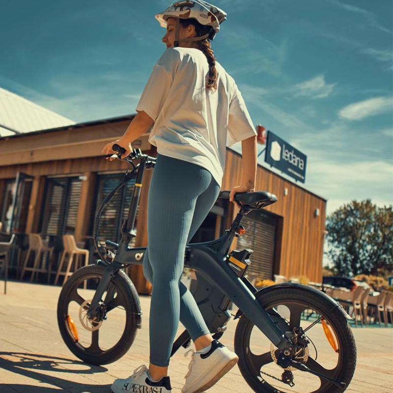 a woman riding a dyu e bike