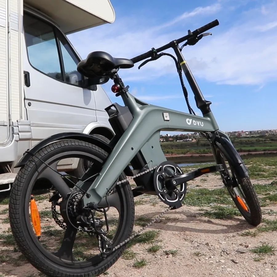 marco trapani is riding a DYU electric bicycle on the road.