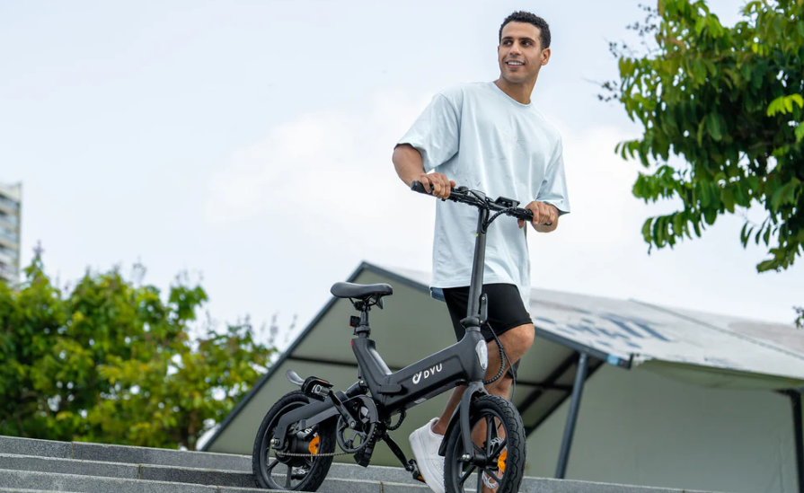 a man riding a folding ebike