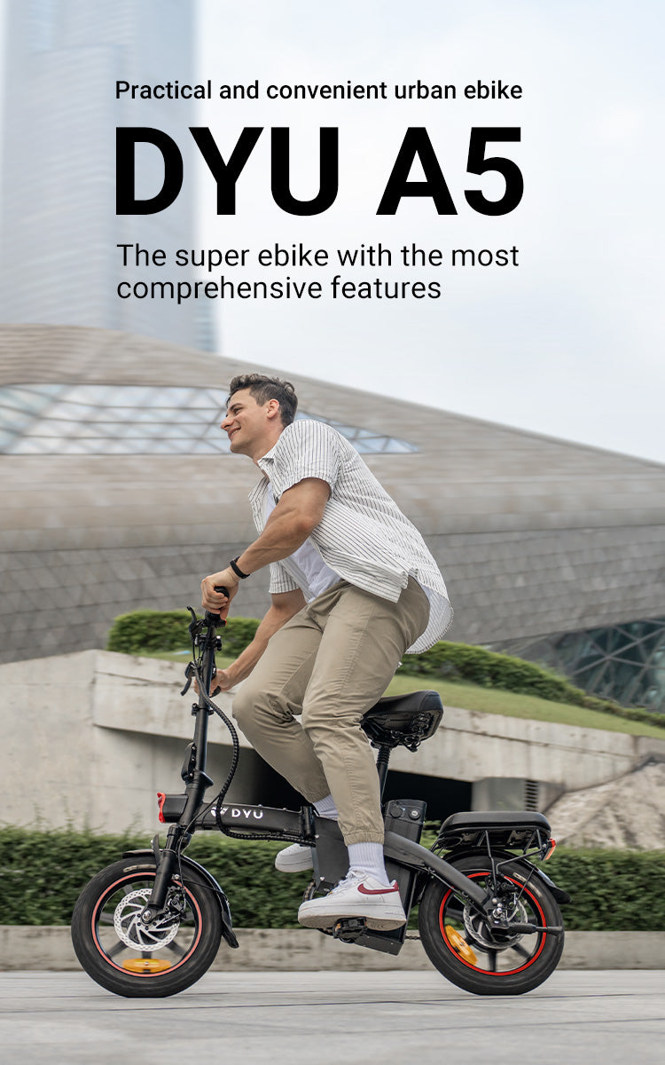 A man is riding a DYU A5 14 Inch Full Foldable Electric Bike on a city road